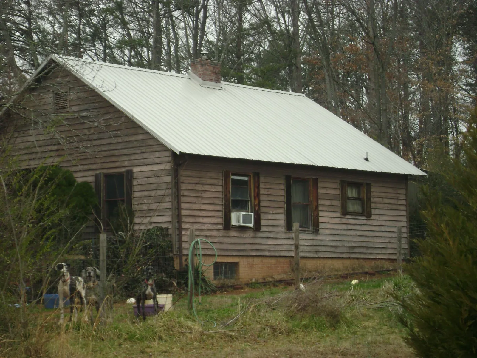 White metal roof on an old wood sided farmhouse, from a Asphalt Shingle Roof Repair job in Rutherford